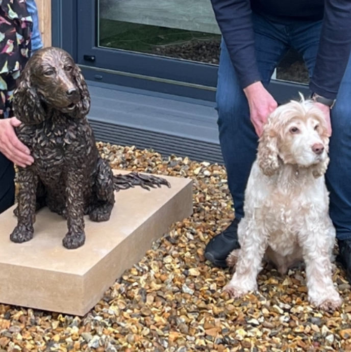 Jasper spaniel statue by JOEL in place with his original and  the happy owner 