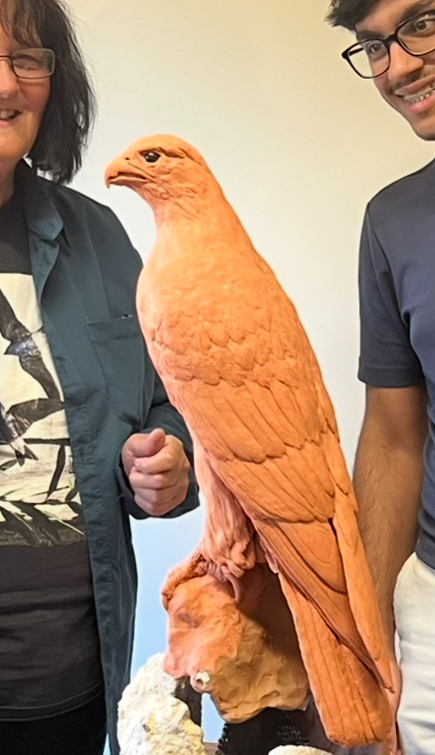 Bird sculpture commission is viewed by the client admiring the detail 