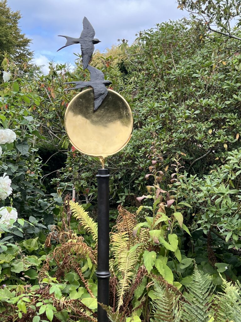 Sun Swallow bronze and golden disc by Joel Walker on a Sunny day