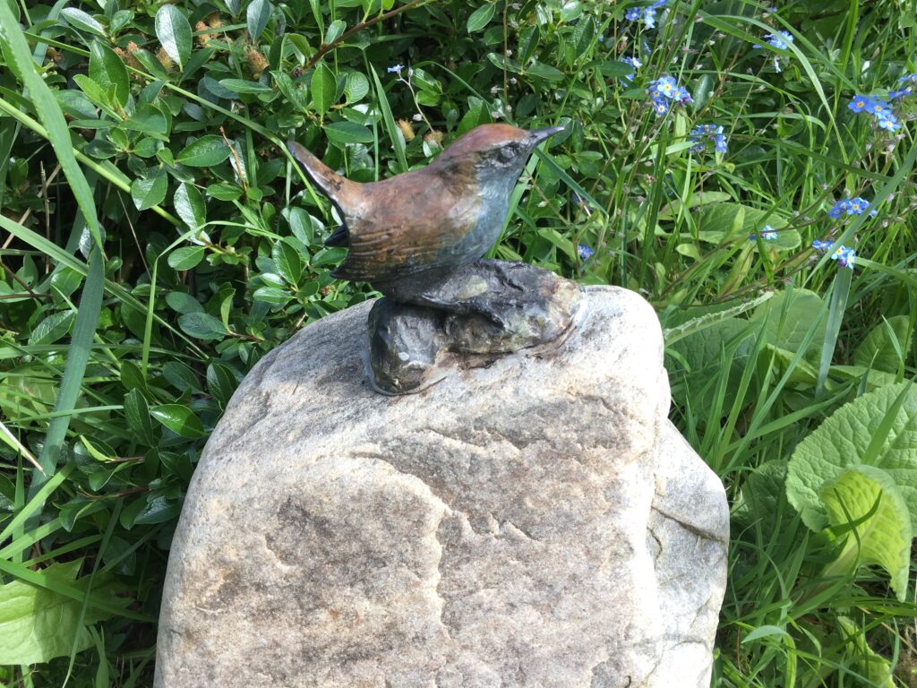 Wren bronze  on rock bird sculpture by Sculptress Joel on unique river rock