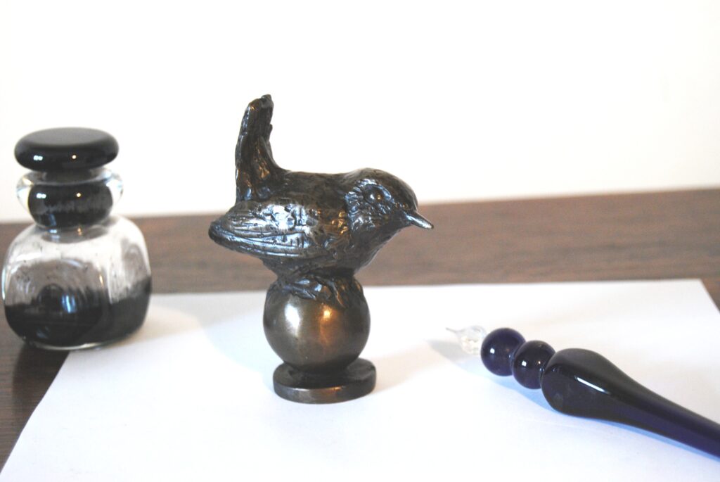 bronze wren sculpture as special anniversary gift - here sitting on the desk