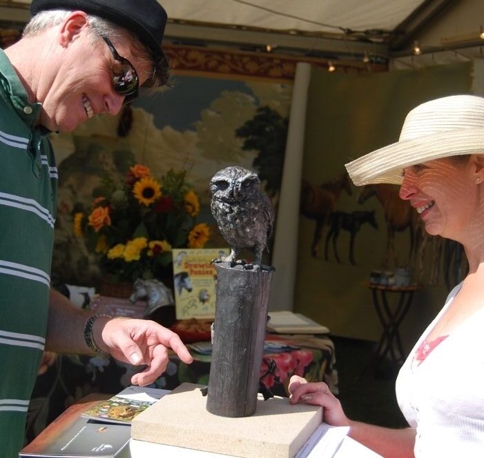 Exhibition visitors admire Little Owl Sculpture by JOEL